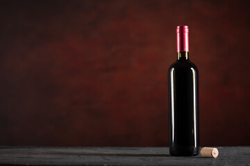 Fototapeta na wymiar Red Wine bottle on a dark background with copy space