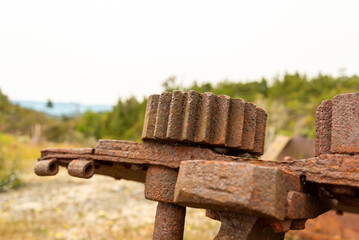 Scrap in the landscape of an old mining factory in the ghost town of Waiuta, New Zealand