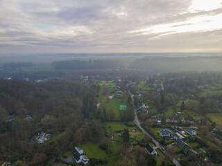 Aerial view of houses surrounded by forest in the country side area of Walloon, Belgium, Europe