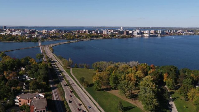 Flying Over John Nolen Drive towards Downtown Madison, Wisconsin Surrounded by Fall Colors (Drone - Push In)