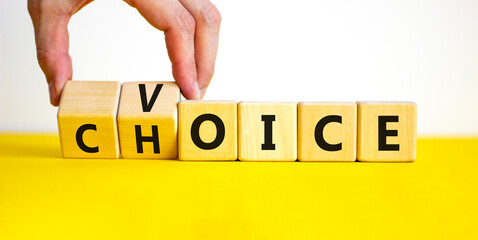 Voice and choice symbol. Businessman turns wooden cubes and changes the concept word choice to...