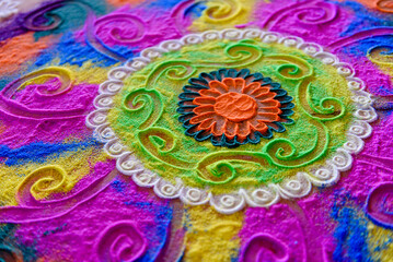 hindu traditional hand drawn colorful Rangoli pattern on the floor
