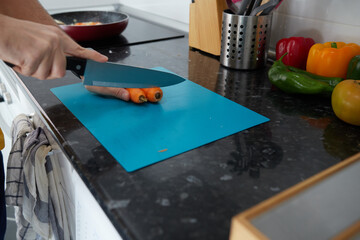 Anonymous person cutting a carrot