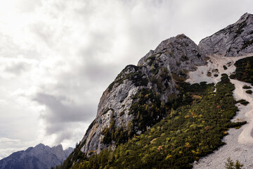 Rock mountain path and green autumn fall forest in Julian Alps, Julijske Alpe, Alpi Giulie, Slovenia Slovenija