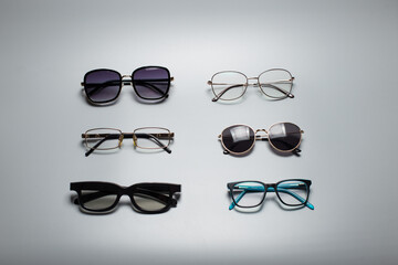 Different eye glasses on grey background.