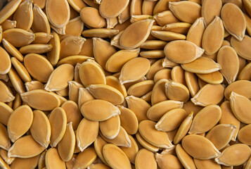 unpeeled pumpkin seeds piled in a pile