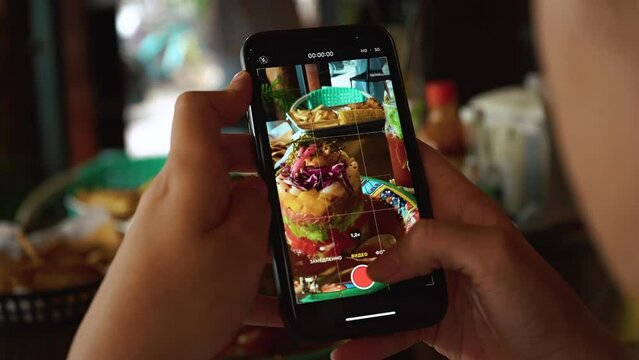 Female hands photographing appetizing food by smartphone. close up shot. Seafood tower. High quality 4k footage