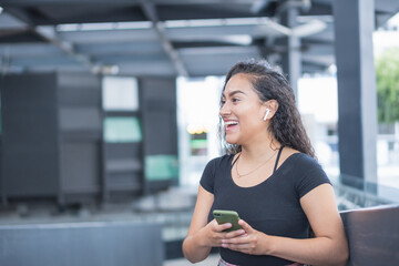 Young woman in the city calling by phone.