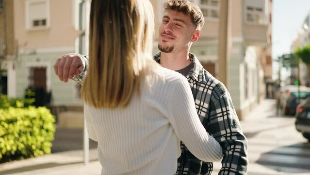 Young couple surprise with anniversary gift standing at street