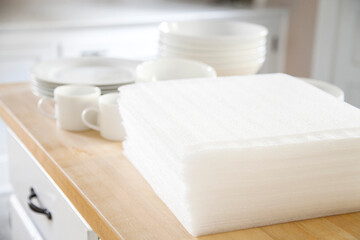 Packing white dishes away with white foam sheets