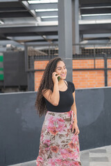 Young woman in the city calling by phone.