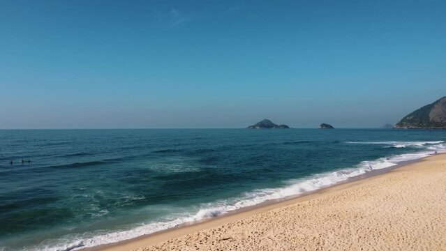 Aerial view of Macumba Beach, a paradise in the west side of Rio de Janeiro, Brazil. Big hills around. Sunny day at dawn. Drone take.
