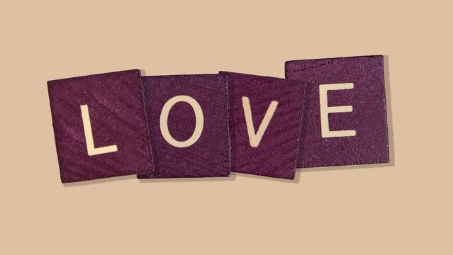 LOVE Word on Natural wood cubes - Animated Love Lettering on the natural beige background. 4 in 1 Professional motion design animation footage templates. 4K romantic postcard for valentine's day
