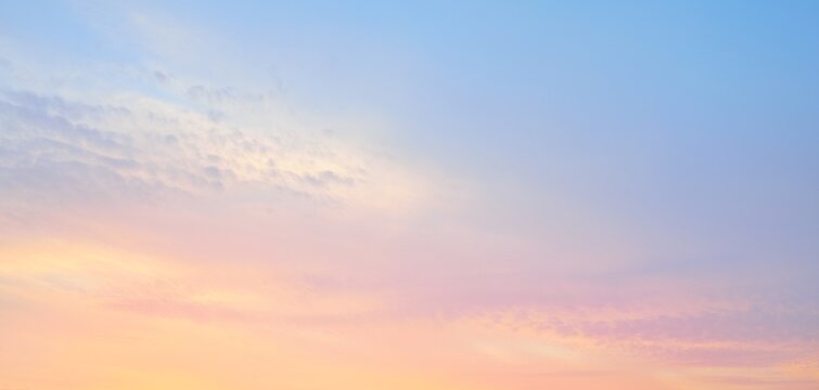 Clear blue sky. Pink and golden glowing clouds. Sunrise. Dramatic cloudscape. Concept art, meteorology, heaven, hope, peace, graphic resources, picturesque panoramic scenery