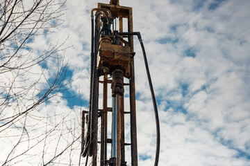 The drilling rig is drilling a well for water. Water extraction on a private plot of land.
