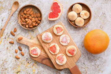 Boards with tasty grapefruit cookies on grunge background