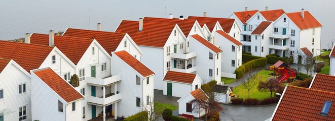 Panoramic aerial view of the modern traditional houses with tiled roofs, falu red dye. Stavanger, Rogaland region, Norway. Architecture, travel destinations, tourism