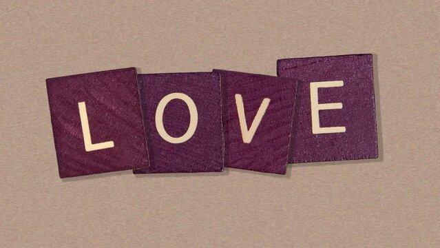 Natural wood texture cubes on love text on Noise paper texture background, valentine card concept. Word of love are made of letters from wood for your girlfriend for Valentines Day greeting card 