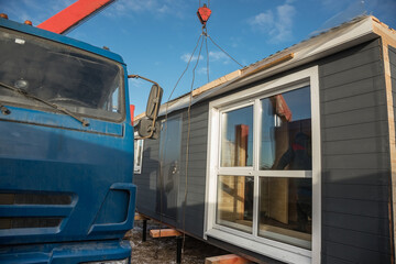 Delivery and installation of a modular frame house. Frame construction of small houses. Modular...