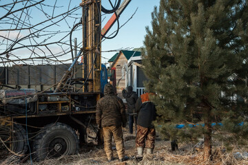 The drilling rig is drilling a well for water. Water extraction on a private plot of land.