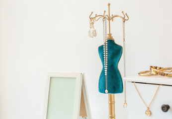 Stylish stand with different jewelry on light background