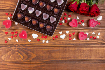 Valentines Day concept chocolate candies and red roses with candles