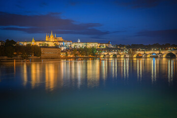 Fototapeta na wymiar Wide angle view of the Prague Castle with the bridge reflection at blue hour