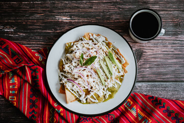 Mexican green chilaquiles with chicken and spicy green sauce traditional breakfast in Mexico	