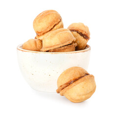 Bowl of tasty walnut shaped cookies with boiled condensed milk on white background