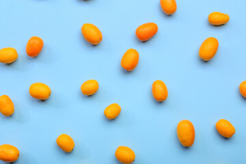 Fototapeta na wymiar Tasty kumquat fruits on blue background