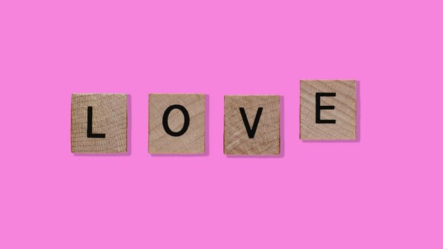 LOVE Word on Natural wood cubes - Animated Love Lettering on a trending pink color background. 4 in 1 Professional motion design animation footage templates. 4K romantic postcard for valentine's day