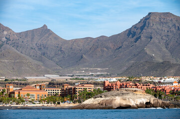 Obraz premium View on resorts and beaches of South coast of Tenerife island during sail boat trip along coastline, Canary islands, Spain
