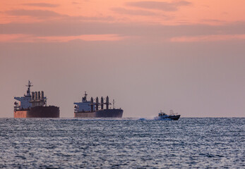 cargo ship in the sea at sunset