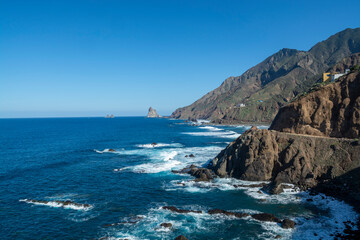 Obraz premium Panoramic view on lava rocks of Playa del Roque de las Bodegas and blue Atlantic ocean, Anaga national park near Tanagana village, North of Tenerife, Canary islands, Spain