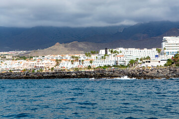 View on resorts and beaches of South coast of Tenerife island during sail boat trip along coastline, Canary islands, Spain