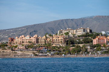 View on resorts and beaches of South coast of Tenerife island during sail boat trip along coastline, Canary islands, Spain