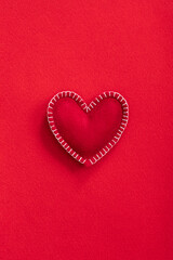 Soft handmade felt heart on red felt background