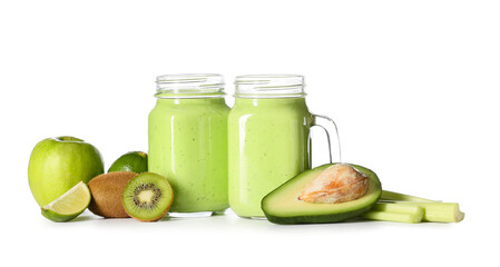 Mason jars of healthy green juice and fresh fruits on white background
