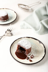 Plate with tasty lava cake fondant on white background