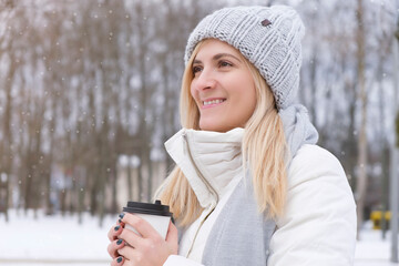 Happy smiling adult tourist woman holding paper coffee cup