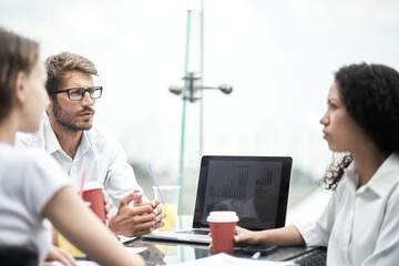 Smiling colleagues working together developing business strategy for their next project. Young casually dressed business people having discussion on sunny terrace. Modern job in comfortable conditions
