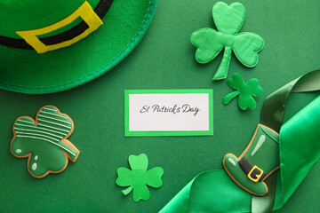 Composition with tasty gingerbread cookies for St. Patrick's Day celebration on green background