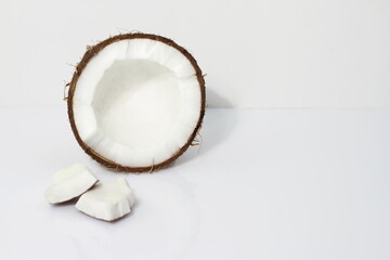 Two halves of coconut on white