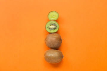 Fresh cut kiwi on orange background