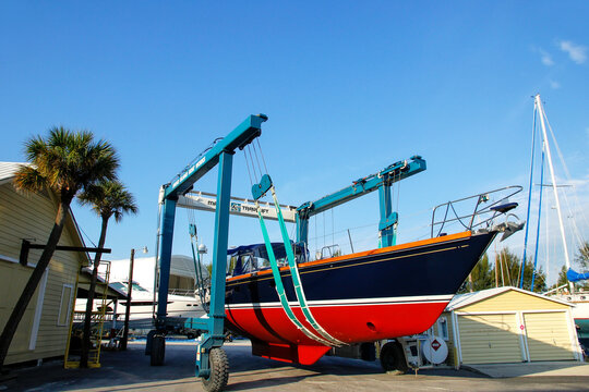 FLORIDA, USA - MARCH 11: Sailboat in a sling at marina warehouse on March 11, 2014 in Florida, USA. Sailing is a very popular activity on the Florida coast