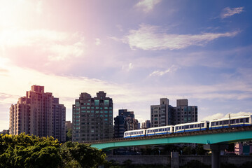 Elevated train passing over bridge. Awesome cityscape with modern metro system