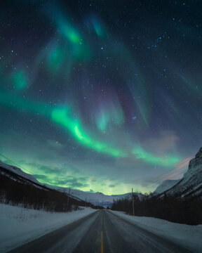 Northern Lights route in the north of Scandinavia. Starry night with aurora borealis in Northern Norway. High quality photo