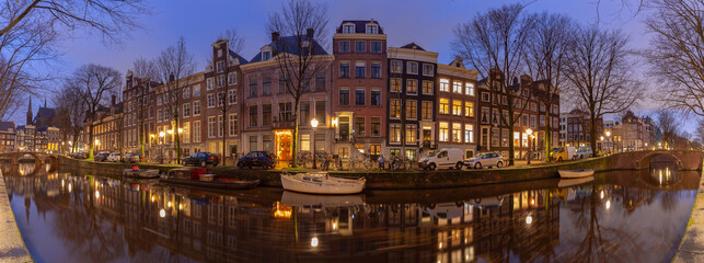 Fototapeta na wymiar Panorama of the city waterfront of Amsterdam at sunset.