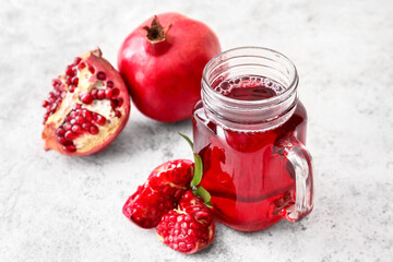 Mason jar of delicious pomegranate juice on white background