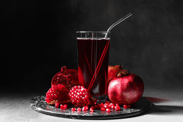 Glass of delicious pomegranate juice on table